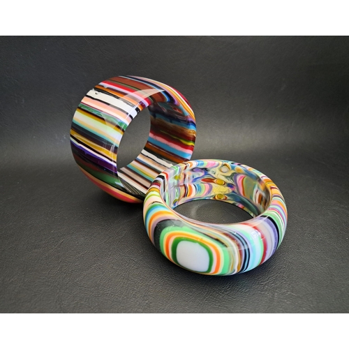 40 - TWO SOBRAL RESIN BANGLES
of colourful striped design, 4.8cm and 3.3cm wide respectively