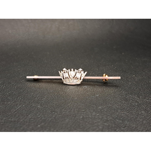 DIAMOND SET BAR BROOCH
the diamonds in the central crown totalling approximately 0.12cts, in fifteen carat gold and platinum, 4.8cm long and approximately 3.2 grams