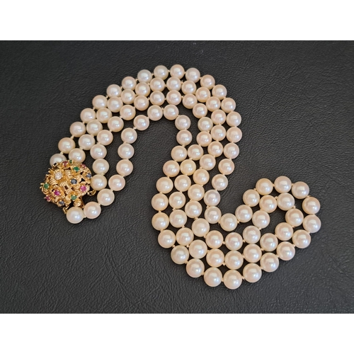 DOUBLE STRAND PEARL NECKLACE
with diamond, ruby, emerald and sapphire set fourteen carat gold clasp of domed design, approximately 42.8cm long