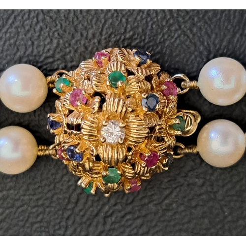 41 - DOUBLE STRAND PEARL NECKLACE
with diamond, ruby, emerald and sapphire set fourteen carat gold clasp ... 