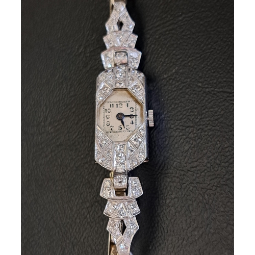 50 - DIAMOND SET PLATINUM CASED COCKTAIL WATCH
on nine carat white gold strap with further diamonds, in a... 