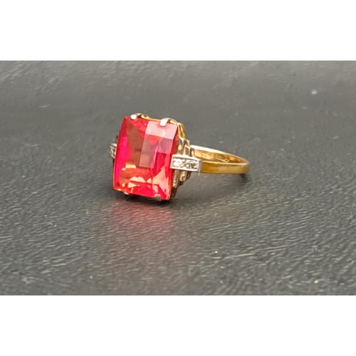 RED GEM AND DIAMOND SET RING
the central checkerboard cut gemstone possibly ruby and measuring 10mm x 8mm x 5mm, flanked by small diamonds to the stepped shoulders, on eighteen carat gold shank, ring size K-L