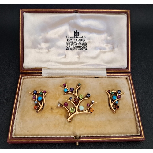 UNUSUAL MULTI GEM SET BROOCH AND MATCHING EARRINGS
all of branch design and set with diamonds, sapphires, rubies, emeralds, opals, peridots, garnets, turquoise and amethyst, in nine carat gold, the brooch approximately 4cm x 4cm, the earrings with clip fastenings and approximately 2.2cm high, total weight approximately 15.1 grams, with fitted box marked 'By Appointment to H.M. The Queen. Goldsmiths & Crown Jewellers. Garrard & Co. Ltd. 112 Regent Street, W1'