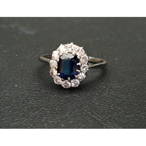 SAPPHIRE AND DIAMOND CLUSTER RING
the oval cut sapphire approximately 1ct in twelve diamond surround totalling approximately 0.6cts, on eighteen carat white gold shank with platinum setting, ring size L and approximately