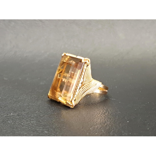 CITRINE DRESS RING
the rectangular step cut citrine measuring approximately 19.6mm x 14.5mm x 8.2mm, with unusual multi strand rope twist effect setting and shoulders, the shank with indistinct mark (tests as eighteen carat gold), ring size L and approximately 9.2 grams