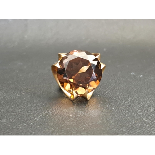 LARGE SMOKY QUARTZ SINGLE STONE DRESS RING
the round cut quartz measuring approximately 17.5mm x 17.5mm x 11.8mm, on nine carat gold shank with decorative scroll setting, ring size K and approximately 8.9 grams