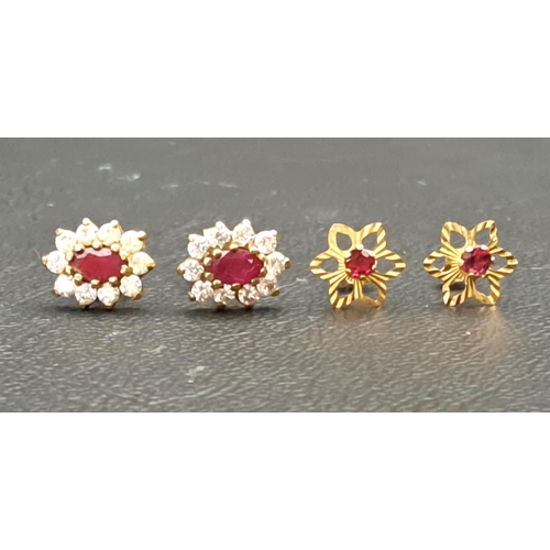 TWO PAIRS OF RUBY SET EARRINGS
comprising a pair of ruby and CZ cluster stud earrings and a pair of flower design earrings with central rubies, both in unmarked gold