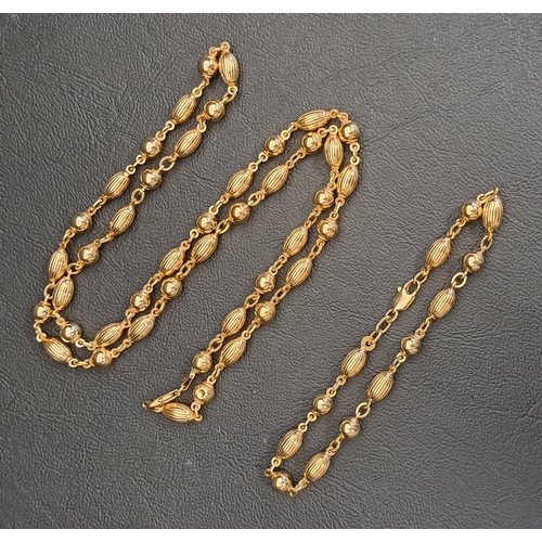 NINE CARAT GOLD NECKLACE AND MATCHING BRACELET
both with alternating round and ribbed oval beads, the necklace 62cm long and the bracelet 20cm long, total weight approximately 27 grams