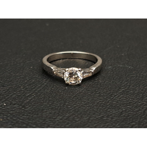 DIAMOND SOLITAIRE RING
the central round brilliant cut diamond approximately 0.6cts flanked by two tapering diamonds to the shoulders totalling approximately 0.12cts, on platinum shank, ring size I and approximately 4.2 grams