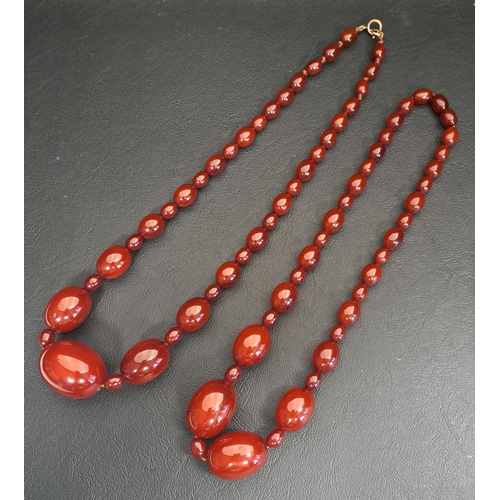 TWO AMBER BEAD NECKLACES
believed to have originally been one larger necklace, the largest bead 3cm long, approximately 48cm and 44cm long respectively, total weight approximately 77.6 grams