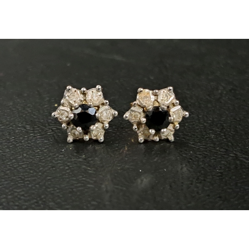 PAIR OF SAPPHIRE AND DIAMOND CLUSTER EARRINGS
the central sapphire on each in six diamond surround, in nine carat gold