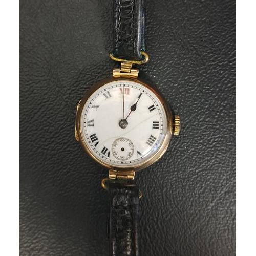 LADIES NINE CARAT GOLD CASED WRISTWATCH
the white enamel dial with Arabic numerals and subsidiary seconds dial, with 15 jewels movement and on leather strap, the inner backplate with London import hallmarks dated 1927