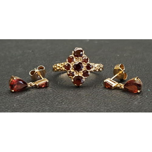 GARNET CLUTER RING AND A PAIR OF GARNET EARRINGS
the cluster ring on nine carat gold, ring size M-N; the earrings with pear cut garnet drops below tapering baguette cut garnets, in unmarked gold