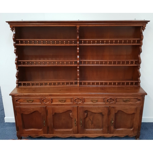CONTINENTAL ELM DRESSER
the upper section with three pairs of galleried plate racks, the base with four panelled frieze drawers and four panelled cupboard doors, standing on stout turned supports, 177.5cm x 190cm x 50cm
