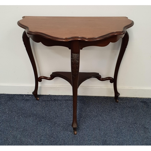 MAHOGANY SIDE TABLE
with a shaped top standing on three carved and shaped supports united by an undertier, 71cm high