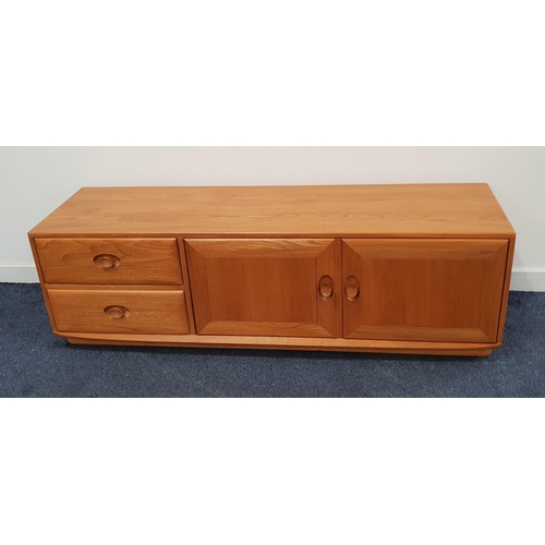 436 - ERCOL GOLDEN DAWN ELM LOW CABINET
with two short drawers and a pair of panelled cupboard doors openi...
