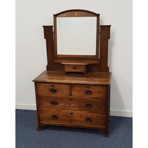 EDWARDIAN OAK DRESSING CHEST
with an arch back and bevelled mirror above a central drawer, the base with two short and two long drawers, 158cm x 100cm x 48cm