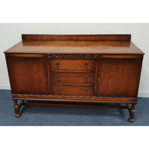 1950s OAK SIDEBOARD
with a raised back above a rectangular top with three central drawers flanked by a pair of cupboard doors, standing on turned front supports, 101cm x 154cm x 56.5cm