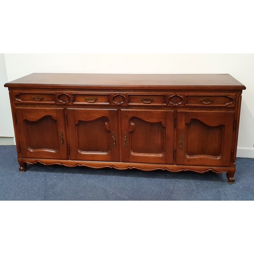 CONTINENTAL ELM SIDEBOARD
with a moulded top above four panelled frieze drawers and four panelled cupboard doors, standing on stout turned supports, 82.5cm x 188.5cm x 50cm