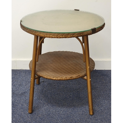 440 - LLOYD LOOM STYLE OCCASIONAL TABLE
with a circular glass covered top with a shelf below, standing on ... 