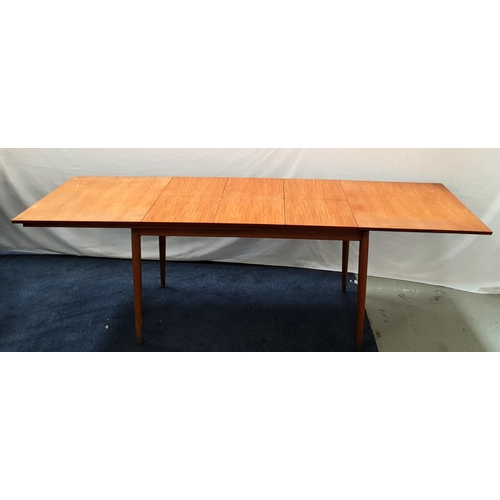 473 - VINTAGE TEAK EXTENDINING TABLE
with a pull apart top revealing three fold out leaves, standing on tu... 