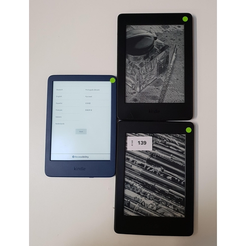 THREE AMAZON KINDLE E-READERS 
comprising 2x Paperwhite 3, serial numbers G090 G105 5266 0S8S and G090 G105 8216 05G9; and a blue Basic 4, serial number G092 AQ05 3477 02NK
Note: one paperwhite 3 with wear to the edges.
Note: It is the buyer's responsibility to make all necessary checks prior to bidding to establish if the device is blacklisted/ blocked/ reported lost. Any checks made by Mulberry Bank Auctions will be detailed in the description. Please Note - No refunds will be given if a unit is sold and is subsequently discovered to be blacklisted or blocked etc.