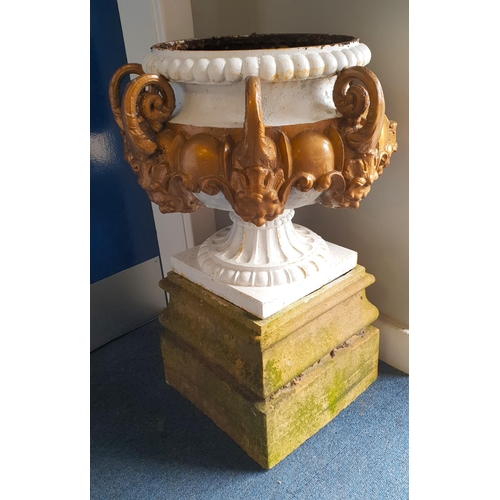 490 - NINETEENTH CENTURY CAST IRON GARDEN URN
raised on a square base with seven scroll and mask handles, ... 