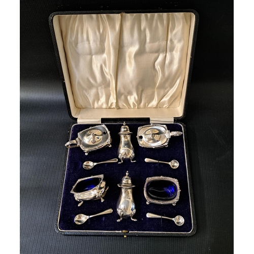 136 - GEORGE V CASED SILVER CRUET SET
comprising two pepper pots, two salts with blue glass liners, two li... 