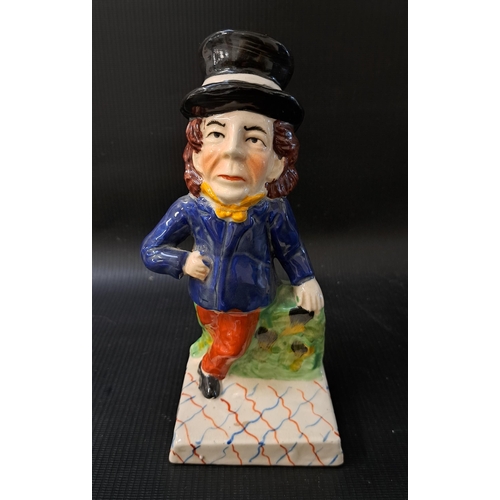 187 - STAFFORDSHIRE FIGURINE
depicting a man in a top hat leaning against a wall, 19.5cm high