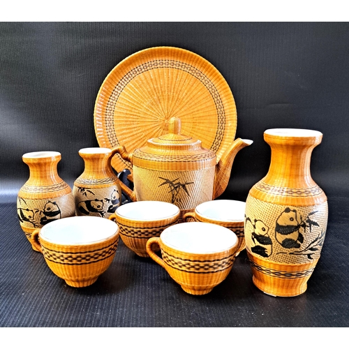 201 - CHINESE VINTAGE BAMBOO COVERED CERAMIC PART TEA SET
comprising teapot, four cups, circular tray, and... 