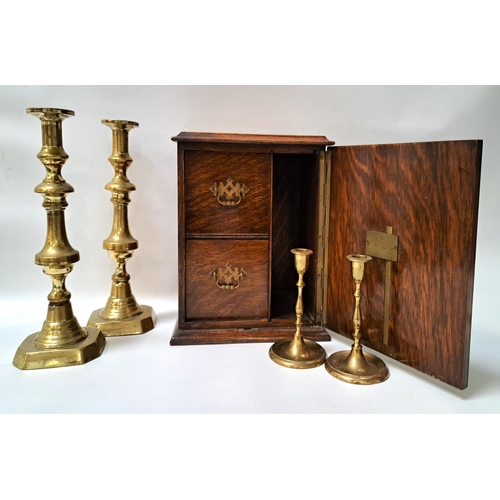 239 - OAK SMOKERS CABINET
with a panelled double arched door opening to reveal two drawers and pipe store,... 