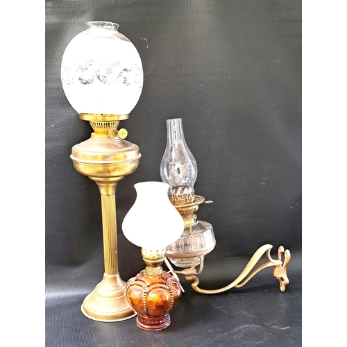 280 - SELECTION OF THREE OIL LAMPS 
comprising a larger brass column example with etched glass shade and f... 