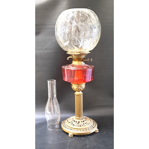 281 - VICTORIAN CRANBERRY OIL LAMP
with ribbed glass shade and funnel, overall height 64cm