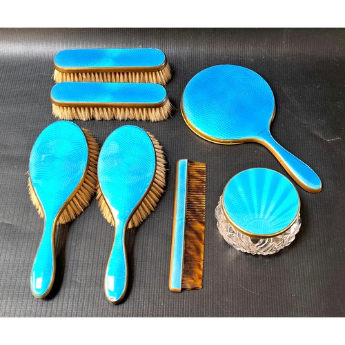 241 - GILT METAL AND GUILLOCHE ENAMEL DRESSING TABLE SET
comprising four brushes, comb, hand mirror and ja... 