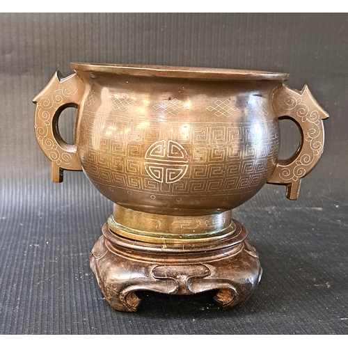 250 - CHINESE BRONZE SHI SHOU CENSER
the circular body with geometric silver inlaid decoration and two sid... 