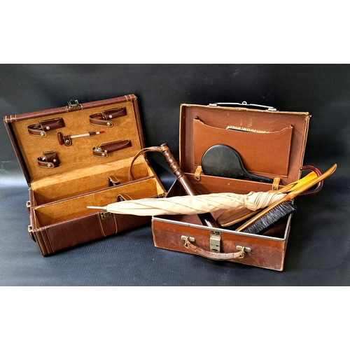 292 - SMALL VINTAGE LEATHER CASE
containing a wooden truncheon, clothes brushes, a parasol and handheld mi... 