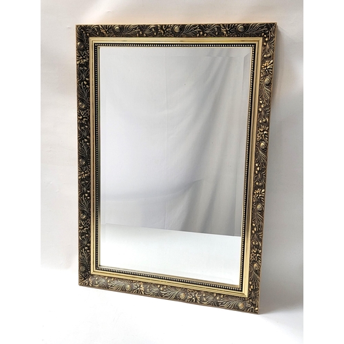 455 - GILT FRAME WALL MIRROR
decorated with leaves and flowers, with a rectangular bevelled plate, 76cm x ... 