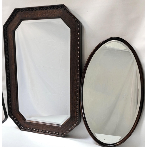 513 - LARGE OAK FRAMED OCTAGONAL MIRROR
with bevelled plate, 93cm x 61cm; together with another smaller ov... 