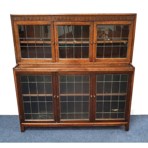 547 - OAK TWO TIERED BOOKCASE
with carved frieze above two astragal glazed doors flanking a glazed panel t... 