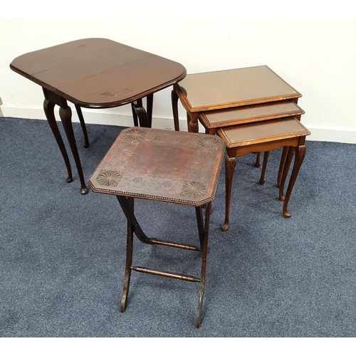 THREE ITEMS OF OCCASIONAL FURNITURE
comprising a stained and carved wood folding table; a nest of three mahogany tables with quarter veneered tops; and a mahogany pembroke table (3)