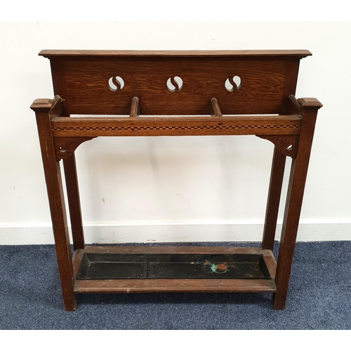 562 - ARTS AND CRAFTS OAK STICK STAND
with tray, circular decoration to the back, 82 x 26 x 84cm