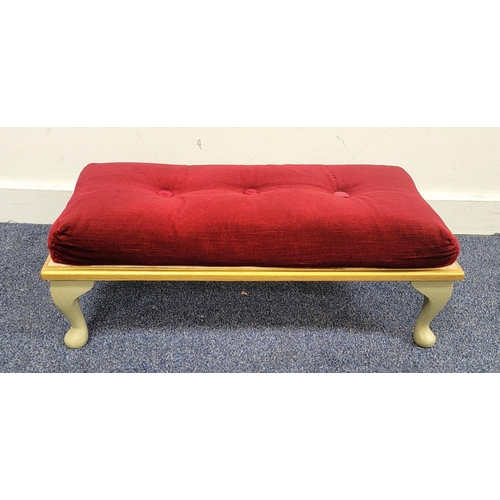 552 - RED VELVET UPHOLSTERED CONTEMPORARY FOOT STOOL
with gilt border and green feet, 68 x 17 x 30cm