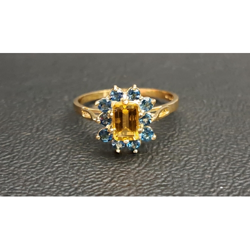 79 - CITRINE AND BLUE TOPAZ CLUSTER RING 
the central emerald cut citrine approximately 0.75cts in ten ro... 