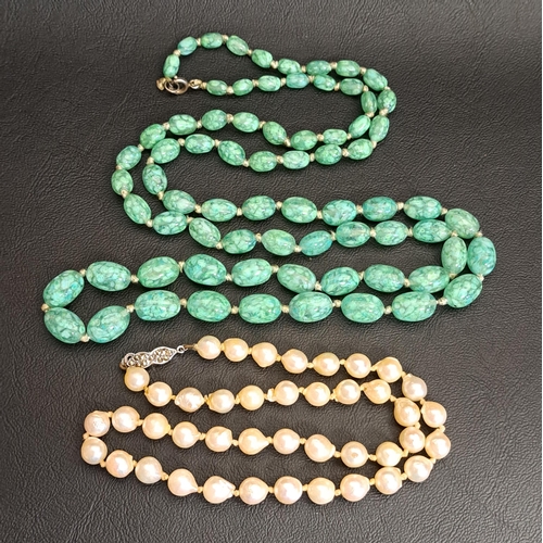 98 - MOTTLED GREEN GLASS BEAD NECKLACE AND A PEARL NECKLACE
the graduated glass bead necklace 93cm long; ... 