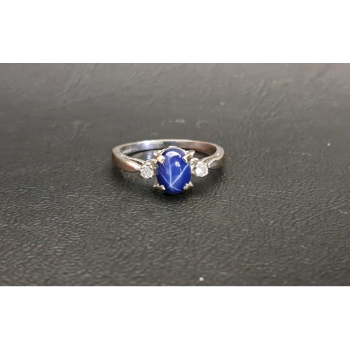 112 - STAR SAPPHIRE AND CZ RING
the central sapphire flanked by a CZ to each side, on white gold plated sh... 