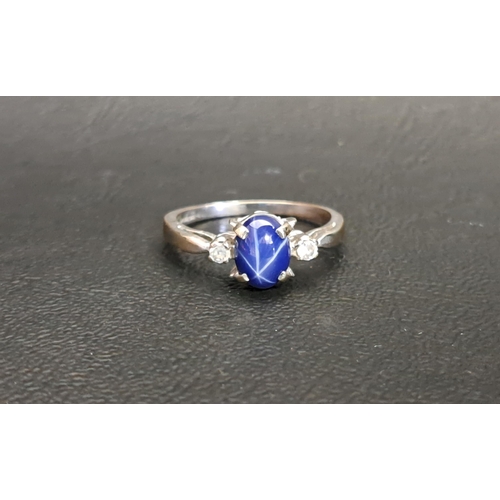 112 - STAR SAPPHIRE AND CZ RING
the central sapphire flanked by a CZ to each side, on white gold plated sh... 