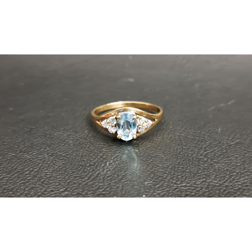 115 - BLUE TOPAZ AND CLEAR GEM SET RING
the central oval cut blue topaz approximately 0.8cts, flanked by t... 