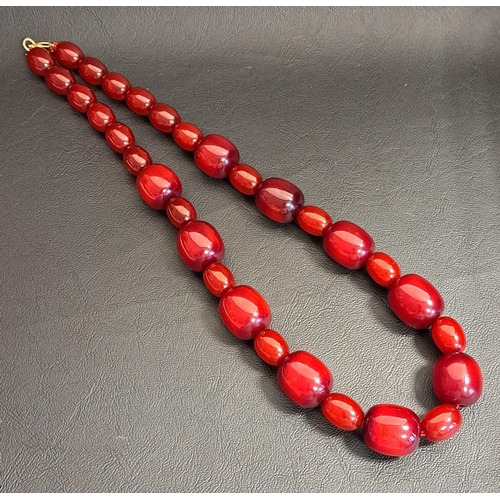 72 - CHERRY AMBER BEAD NECKLACE
the front section with alternating larger and smaller beads, the largest ... 