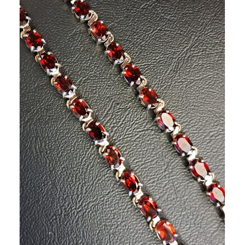 40 - GARNET LINE NECKLACE
set with fifty-five oval cut garnets, each of approximately 0.65cts, in silver,... 