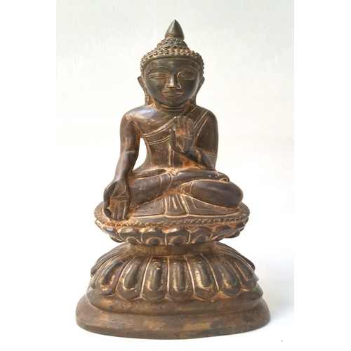 244 - BRONZE FIGURE OF A BURMESE BUDDHA
seated on a double lotus pedestal, his left hand raised, his right... 